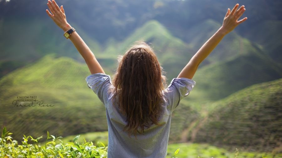 Woman with hands outstretched praising God