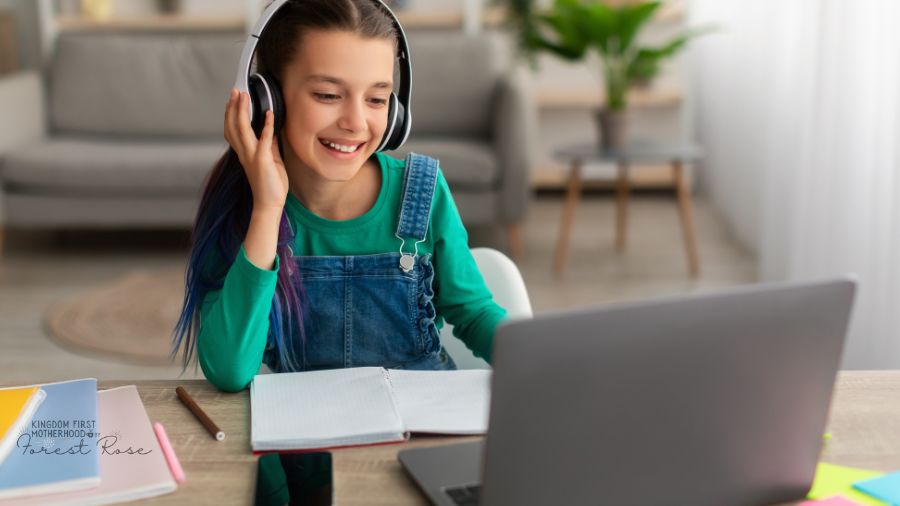 Young girl with headphones on and laptop - Inspire kids to take up new hobbies 