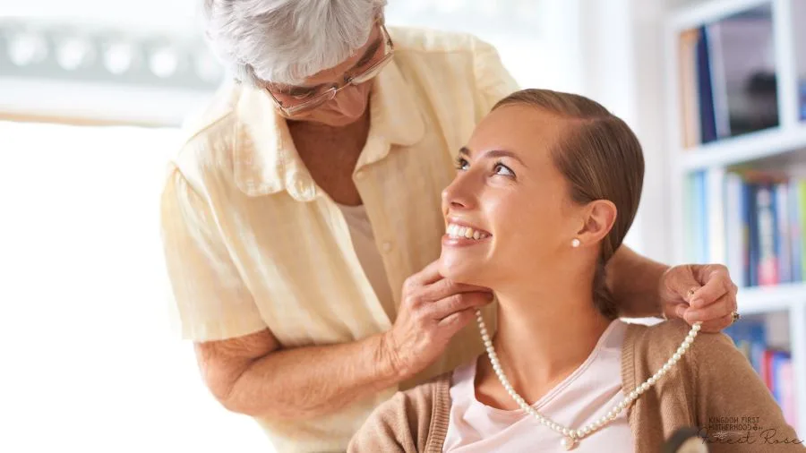 Grandma putting family heirloom pearl necklace on granddaughter 