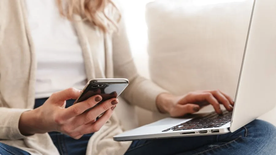 Woman on phone and laptop