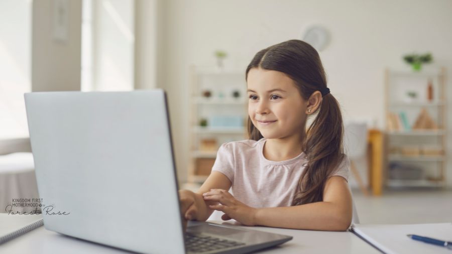 young girl doing online school work on laptop