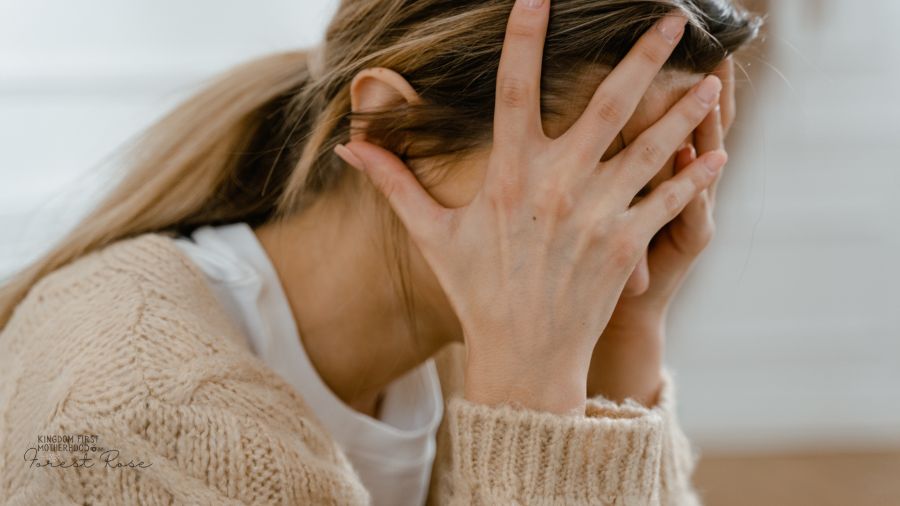 woman holding her head and struggling to get things done